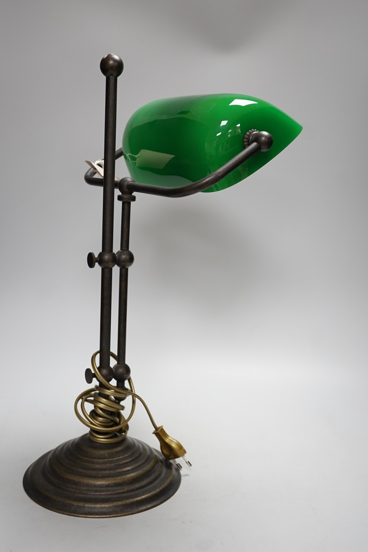 A green glass and brass student lamp, 48cms high